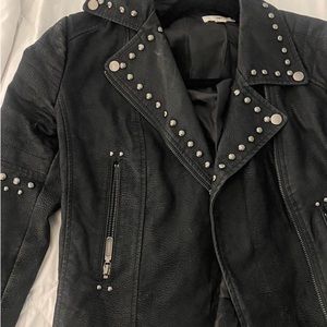 Black fitted leather jacket with silver/gunmetal studs and zipper detailing.